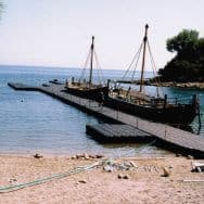 Floating platform at the end of a beach with access to boats