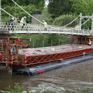 Pontoon floating on water with bridge under repair