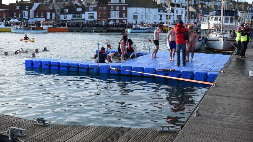 Swimmers in water approaching a Pontoonworks floating platform solution