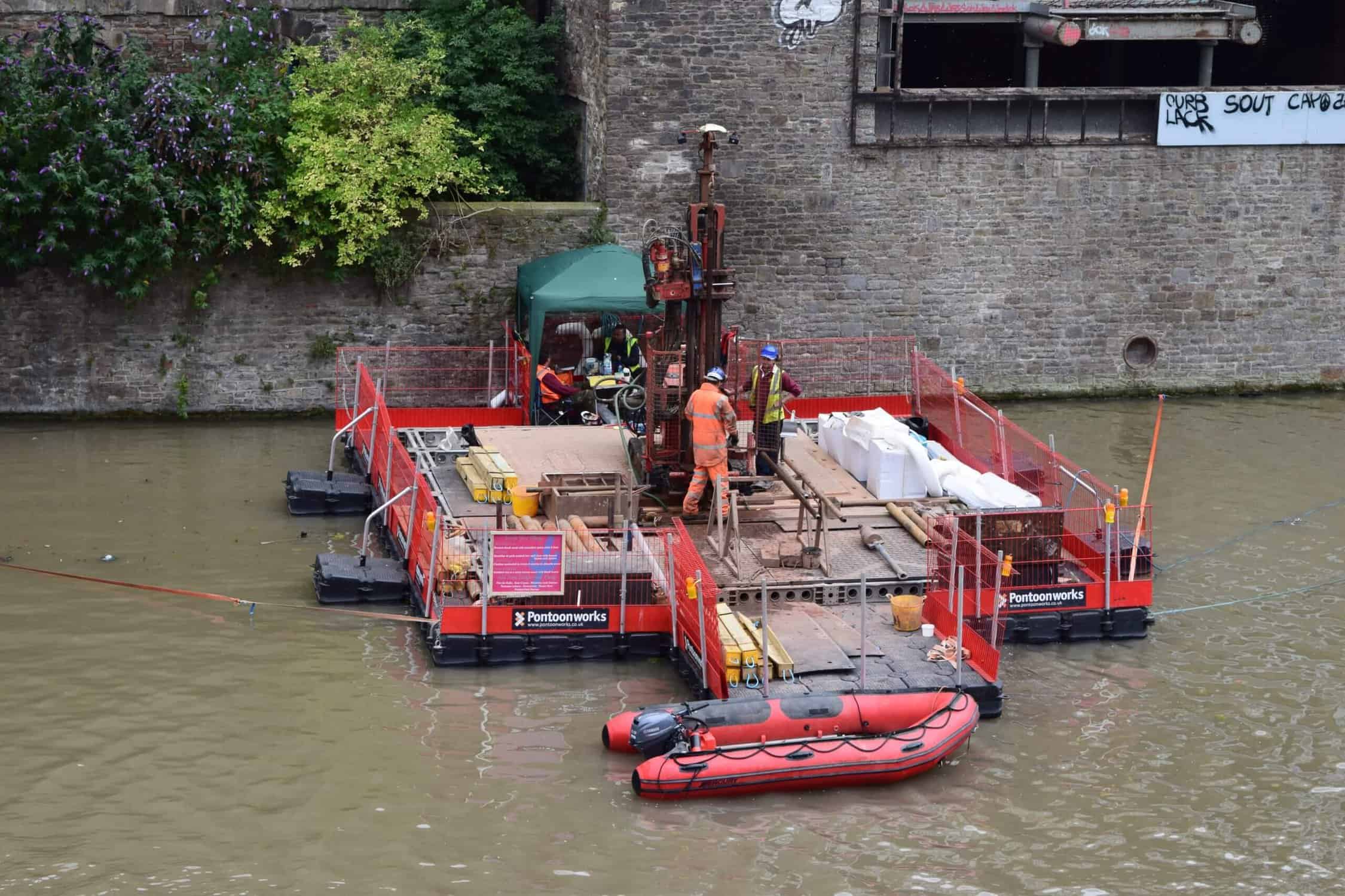 Men working on a pontoon in a river